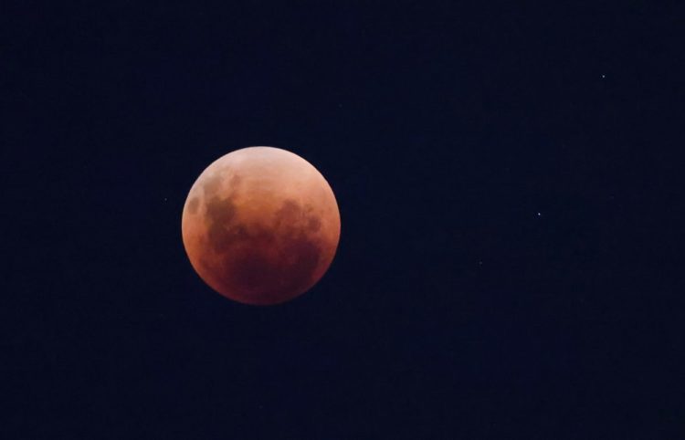 A total lunar eclipse dubbed the 'blood' moon is pictured in Santiago, Chile, May 15, 2022. Picture taken May 15, 2022. REUTERS/Pablo Sanhueza